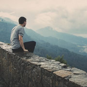 Person sitting on mountain